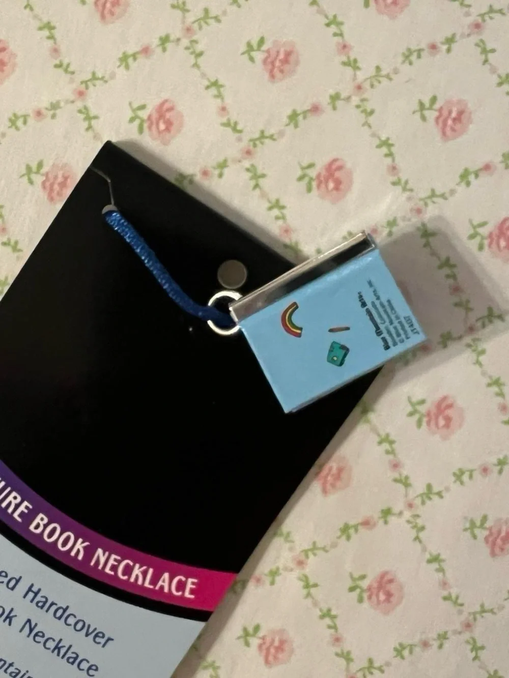 Miniature poetry book necklace.  “You are an amazing girl”.